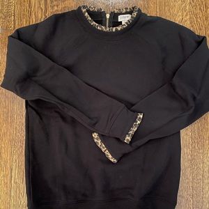 Black woven ruffle neck pullover.
